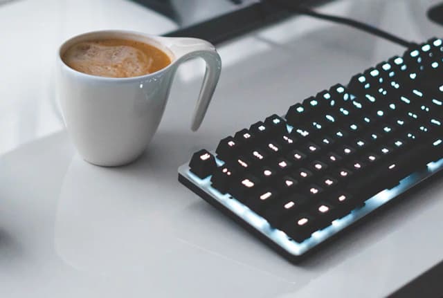 keyboard and coffee on a table